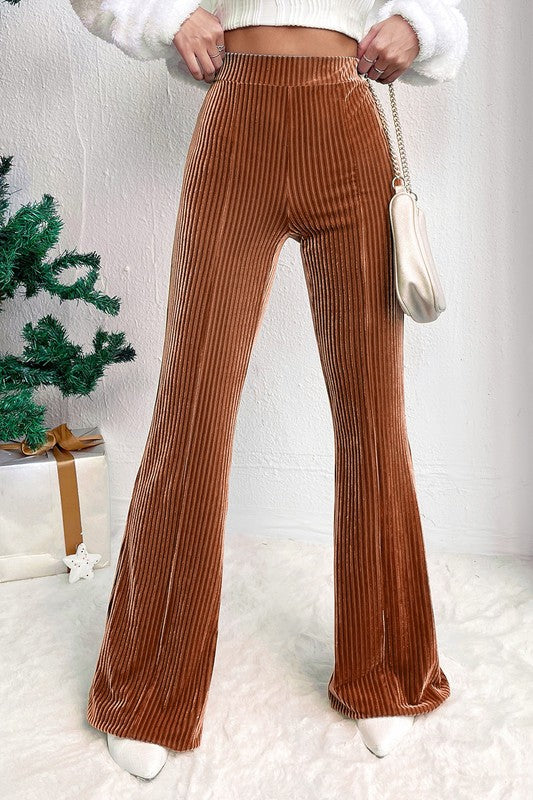 Brown ribbed pants worn by a person with a white background