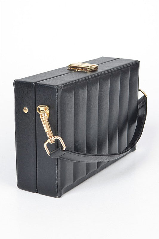 Black handbag with gold accents on a white background