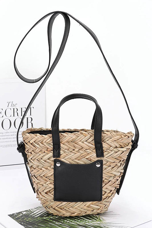 Woven handbag with black accents on a white background