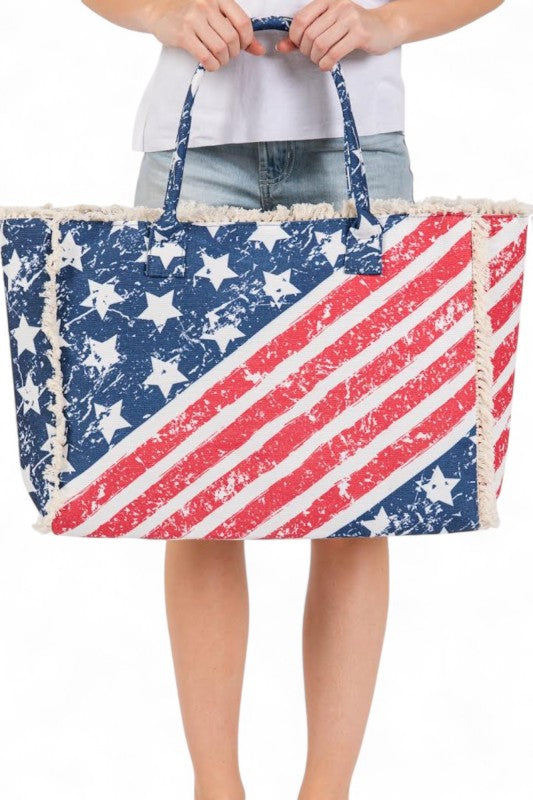 Tote bag with American flag design held by a person