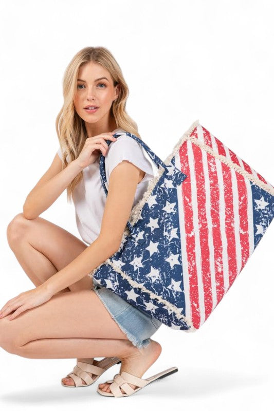 Woman holding a large American flag-patterned bag on a white background