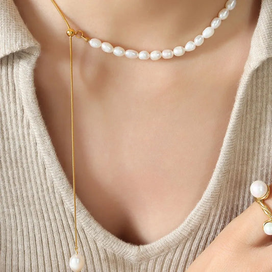 woman wearing a gold and pearl necklace