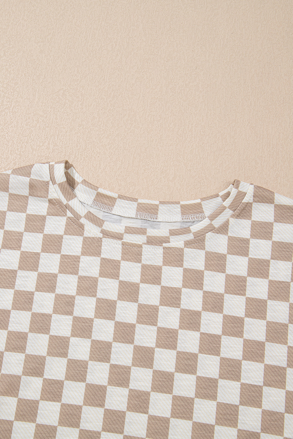 Checkered shirt with brown and white pattern on a beige background