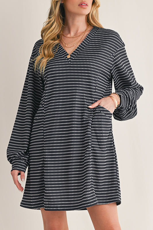 Woman wearing a black and white patterned dress on a beige background