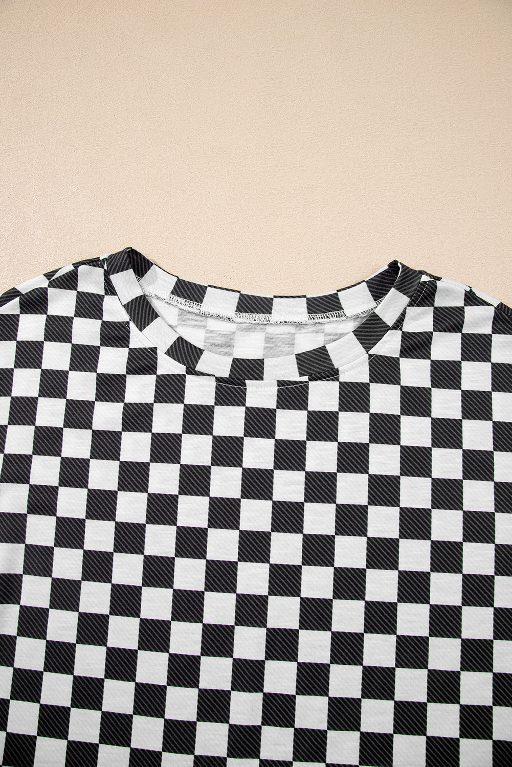 Black and white checkered shirt on a beige background