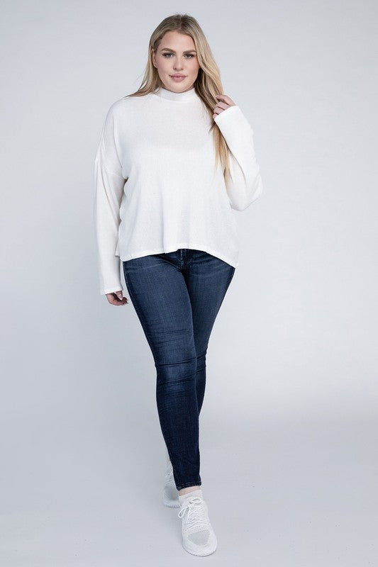Woman wearing a white turtleneck sweater and blue jeans on a white background