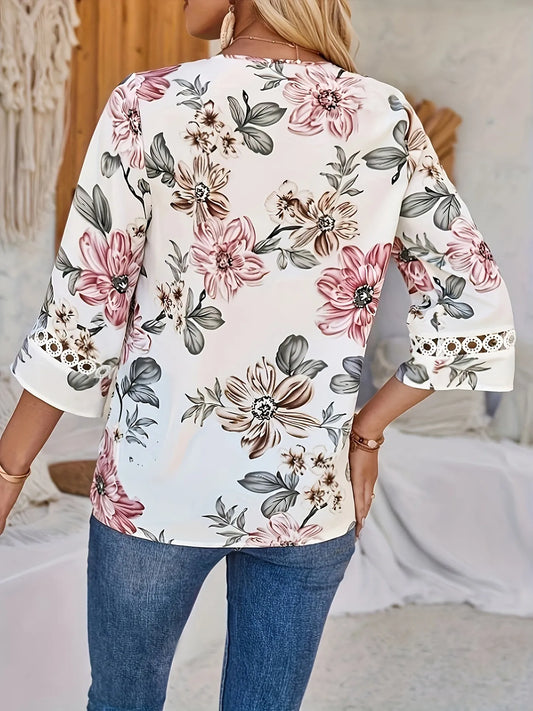 Woman wearing a floral blouse with rolled-up sleeves in an indoor setting