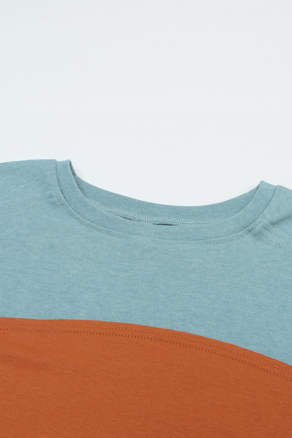 Two-tone blue and brown shirt on a light blue background