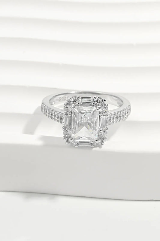 Diamond ring with a rectangular stone on a white surface