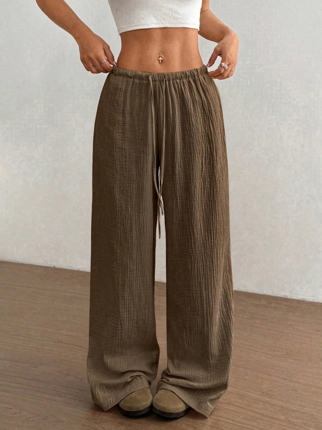 Brown wide-leg pants worn by a person on a plain background