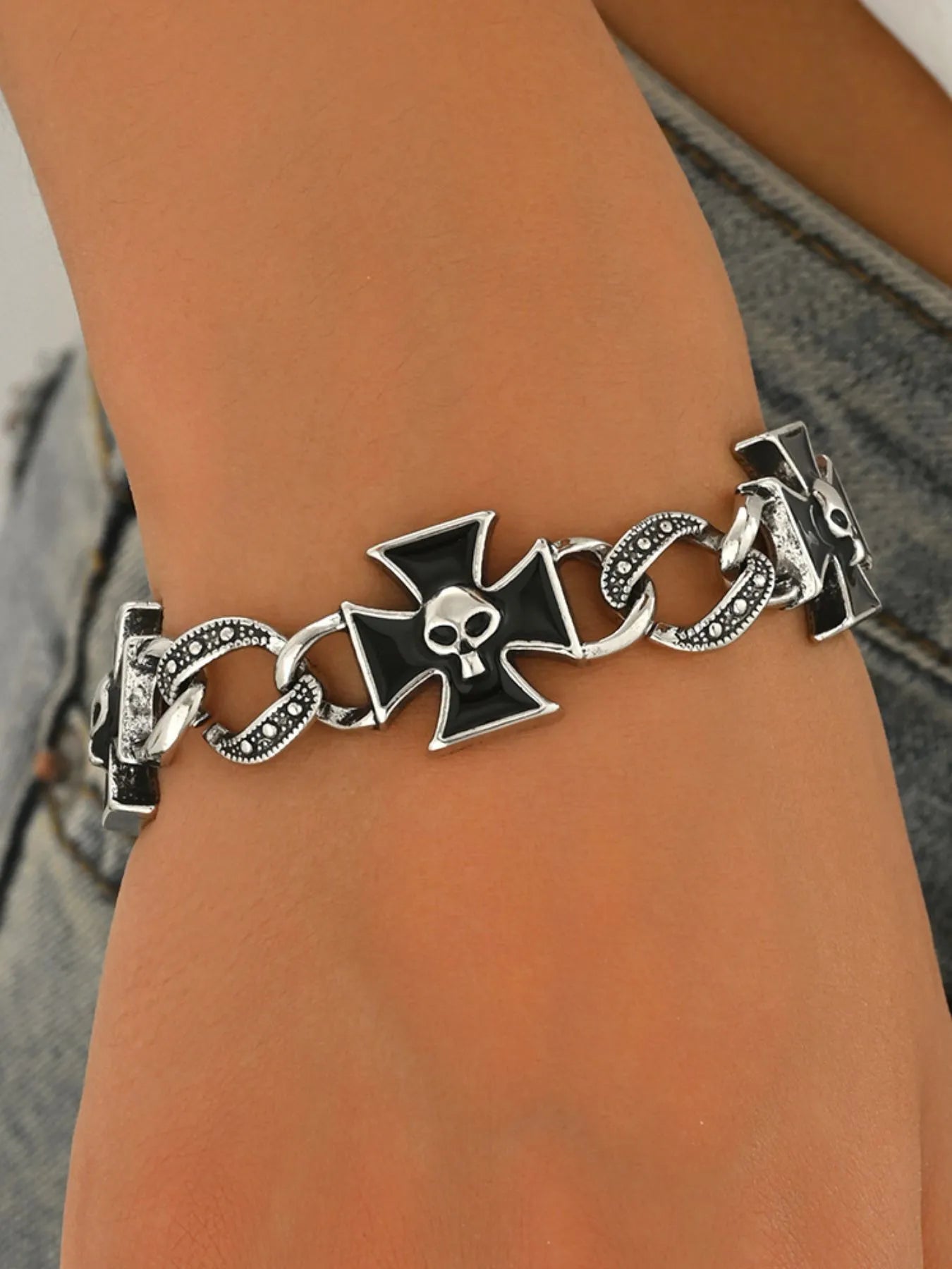 Bracelet with skull and crossbones design on a wrist