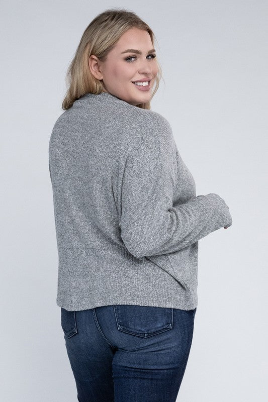 Person wearing a gray sweater and blue jeans on a white background