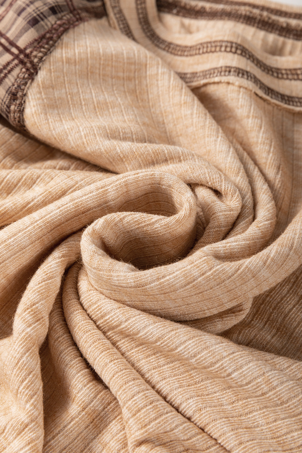 Close-up of beige fabric with a subtle pattern