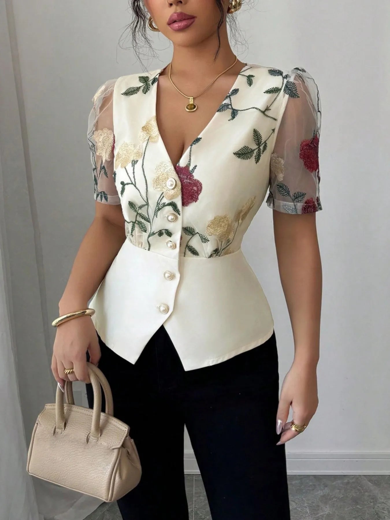 Woman wearing a floral blouse with a plain background