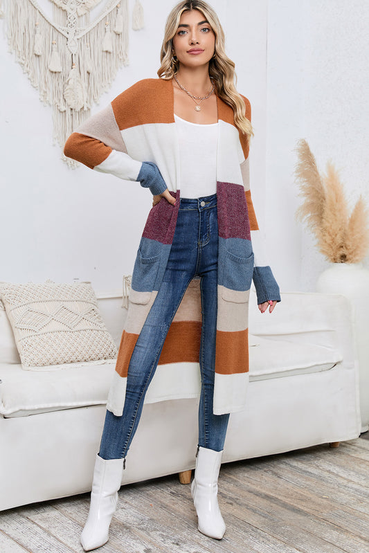 Woman wearing a colorful cardigan and jeans in a living room setting