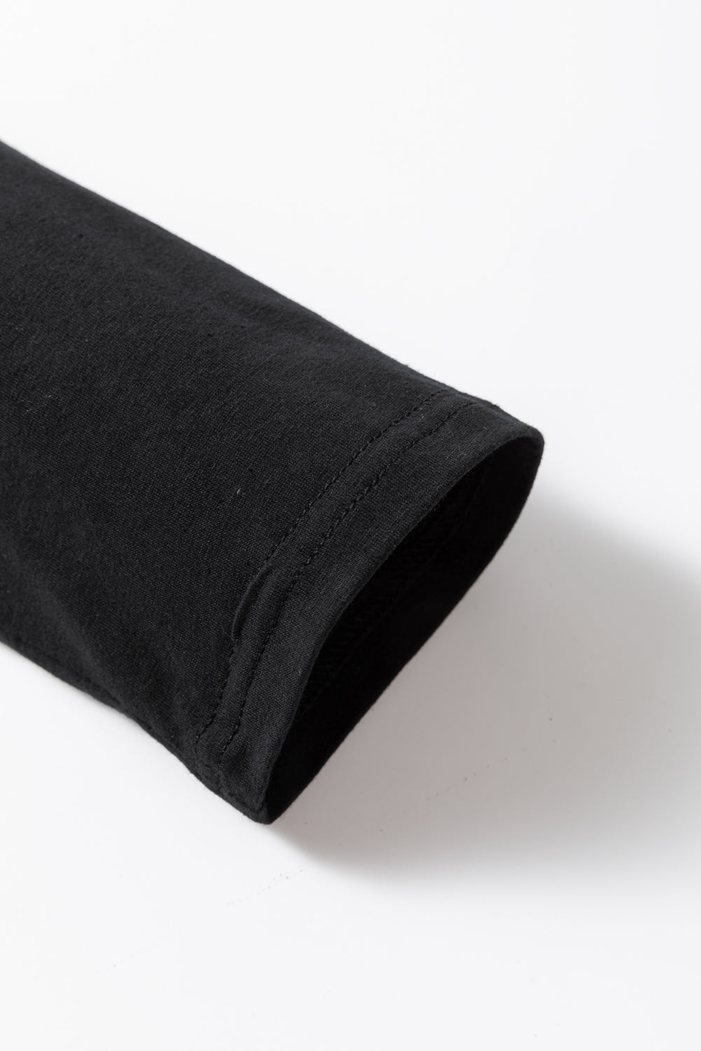 Rolled-up black sleeve on a white background