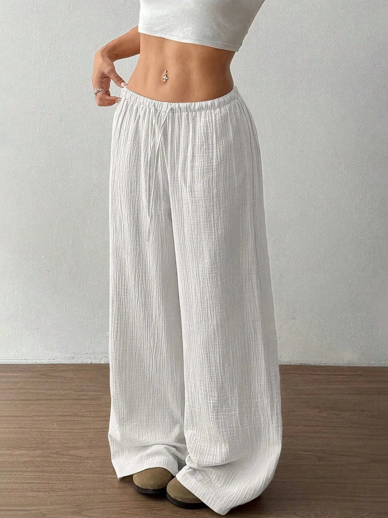White wide-leg pants worn by a person on a plain background