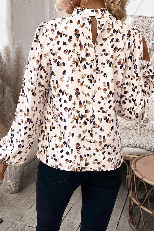 Woman wearing a patterned blouse with a blurred background
