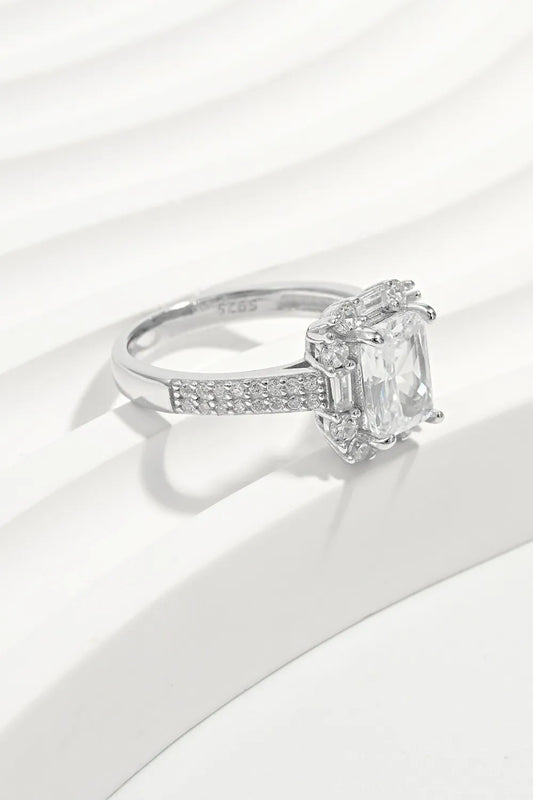 Diamond ring with a rectangular stone on a white background