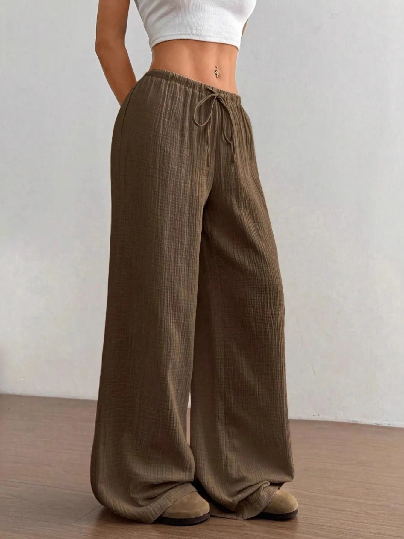 Brown wide-leg pants worn by a person on a plain background