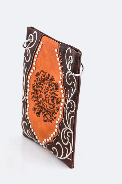 Decorative leather pouch with brown and orange design on a white background