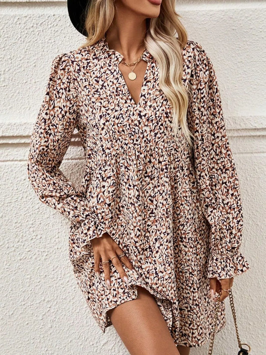 Woman wearing a floral dress against a white wall