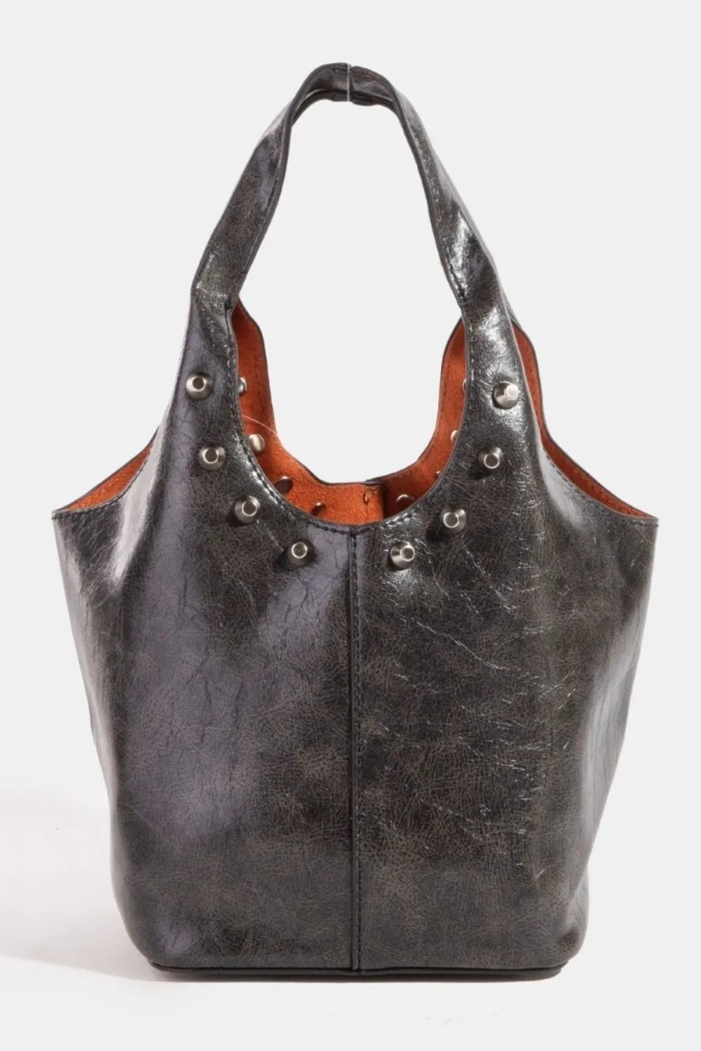 Black leather handbag with brown interior and decorative studs on a white background