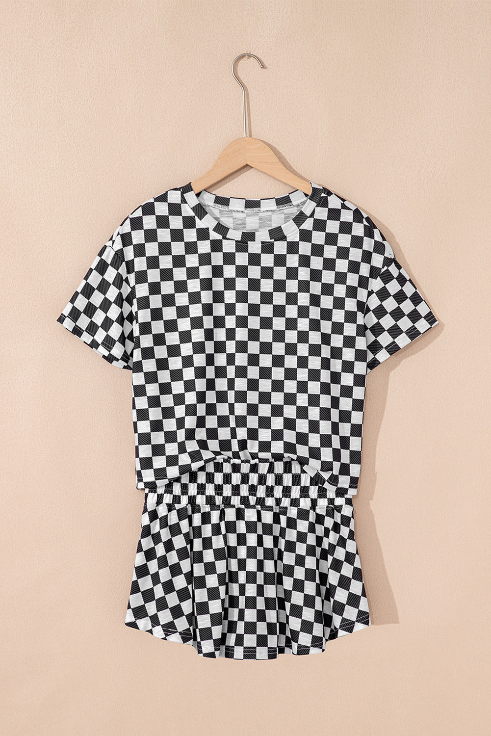 Black and white checkered dress on a beige background