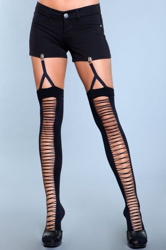Black strappy thigh-high stockings worn with black shorts on a gray background