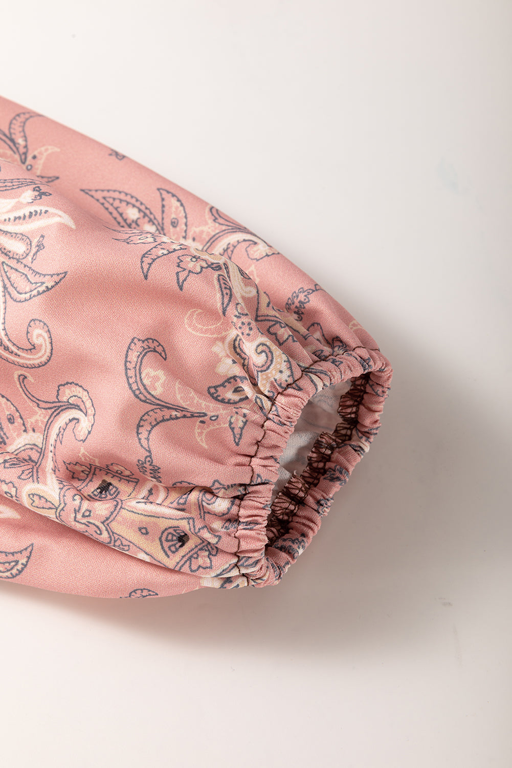 Pink patterned fabric on a white background