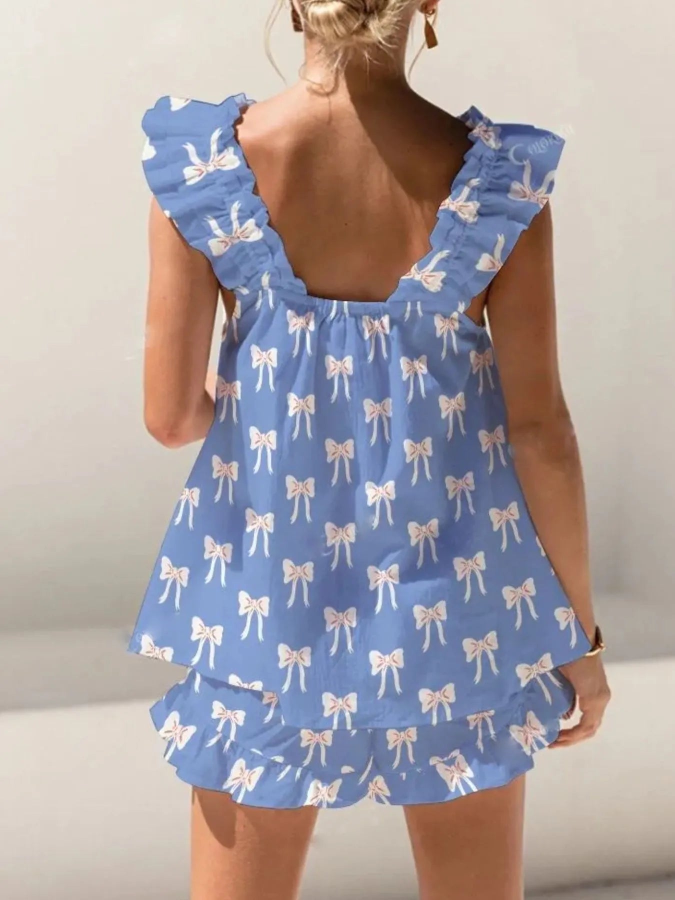 Blue dress with bow pattern on a plain background