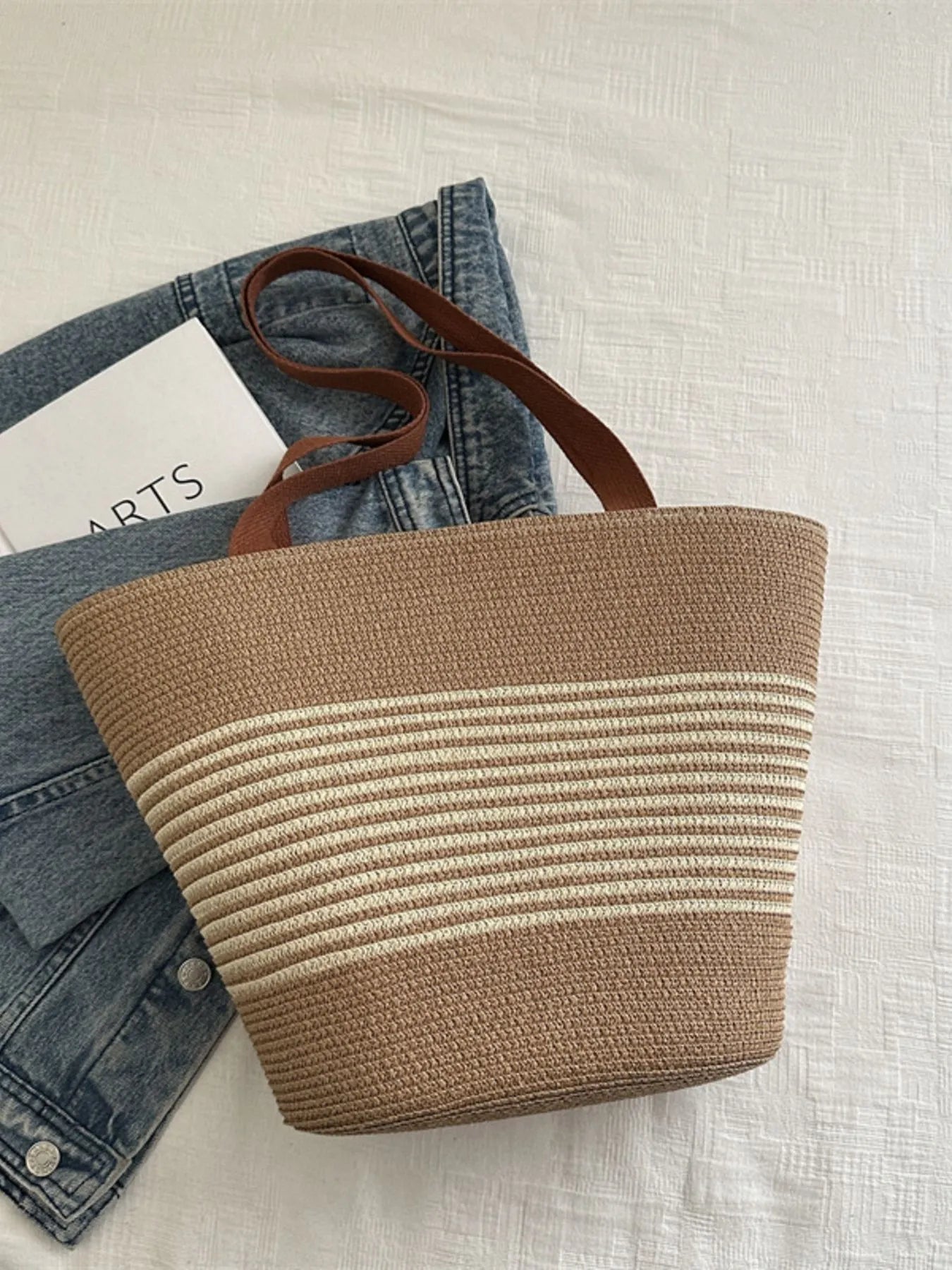 Brown and beige striped tote bag on a light background
