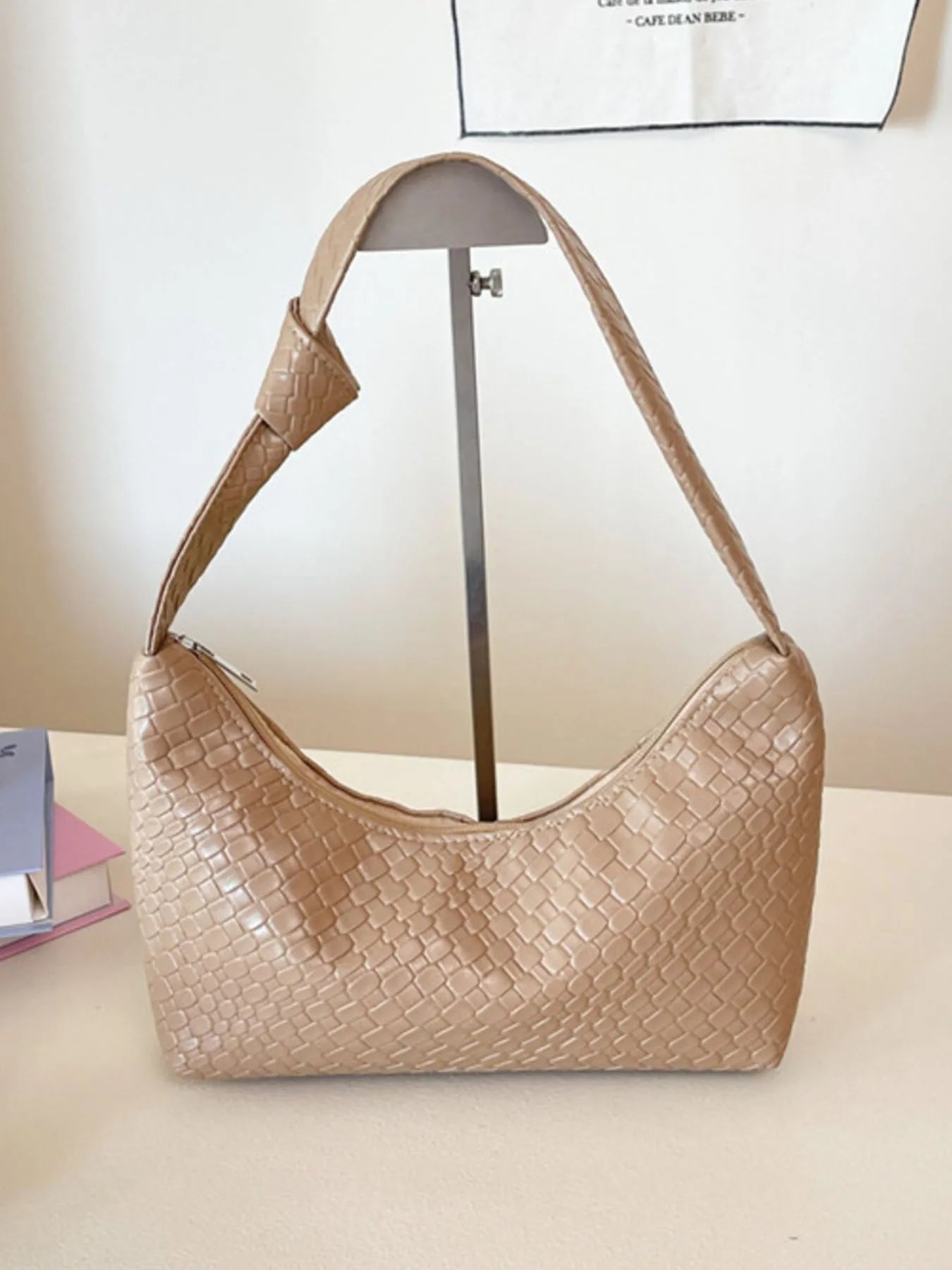 Beige handbag with textured pattern on a light background
