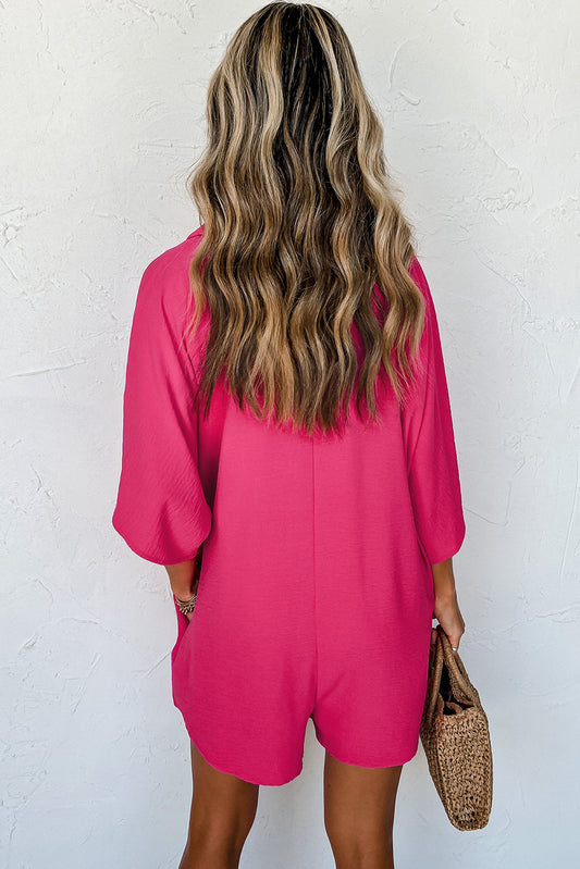 Person wearing a bright pink dress against a white wall