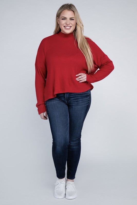 Woman wearing a red sweater and blue jeans on a white background