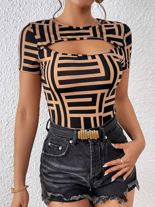 Person wearing a black and beige geometric patterned top with denim shorts on a white background