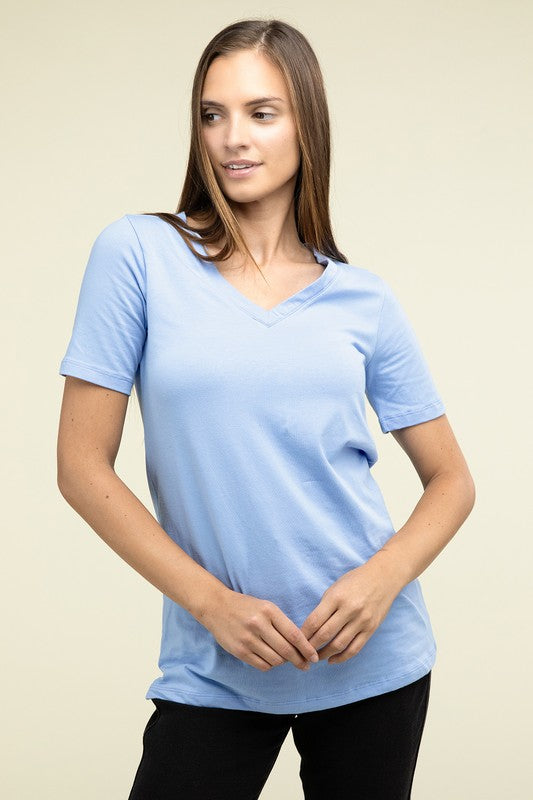 Woman wearing a light blue t-shirt against a beige background