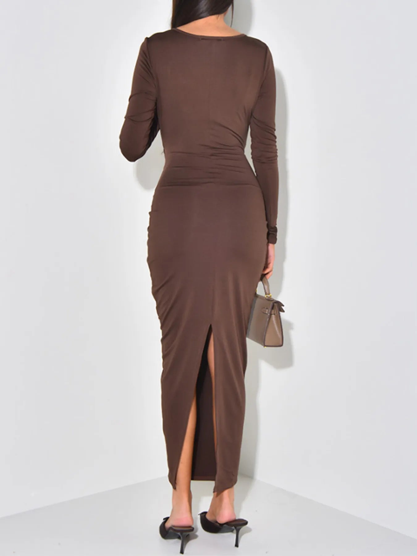 Brown long-sleeve dress with a slit on a white background