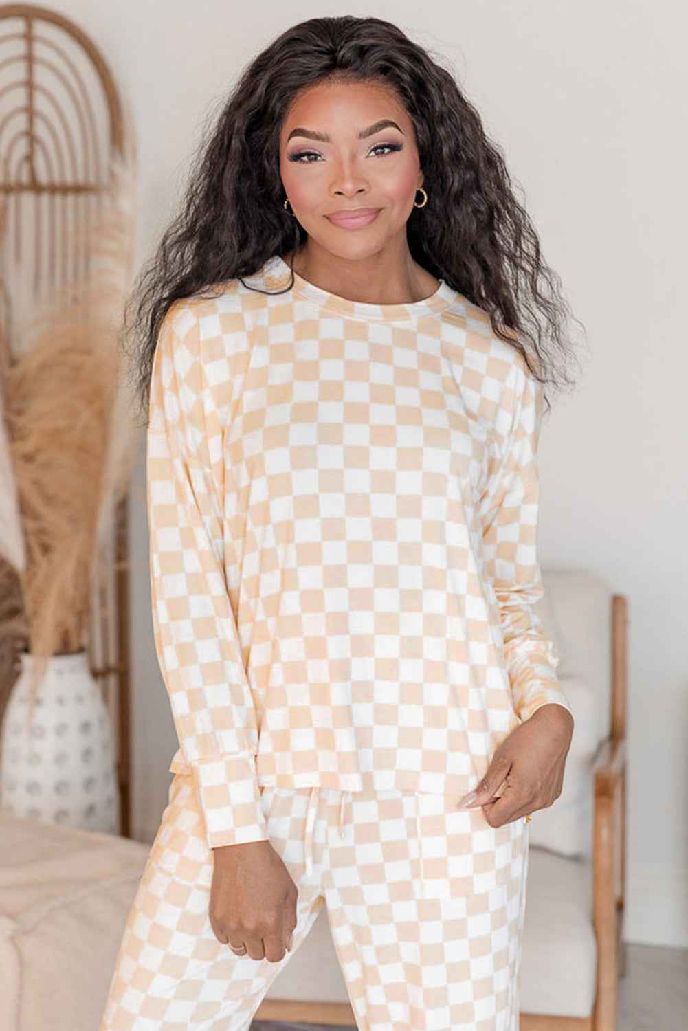 Woman wearing a checkered outfit in a home setting