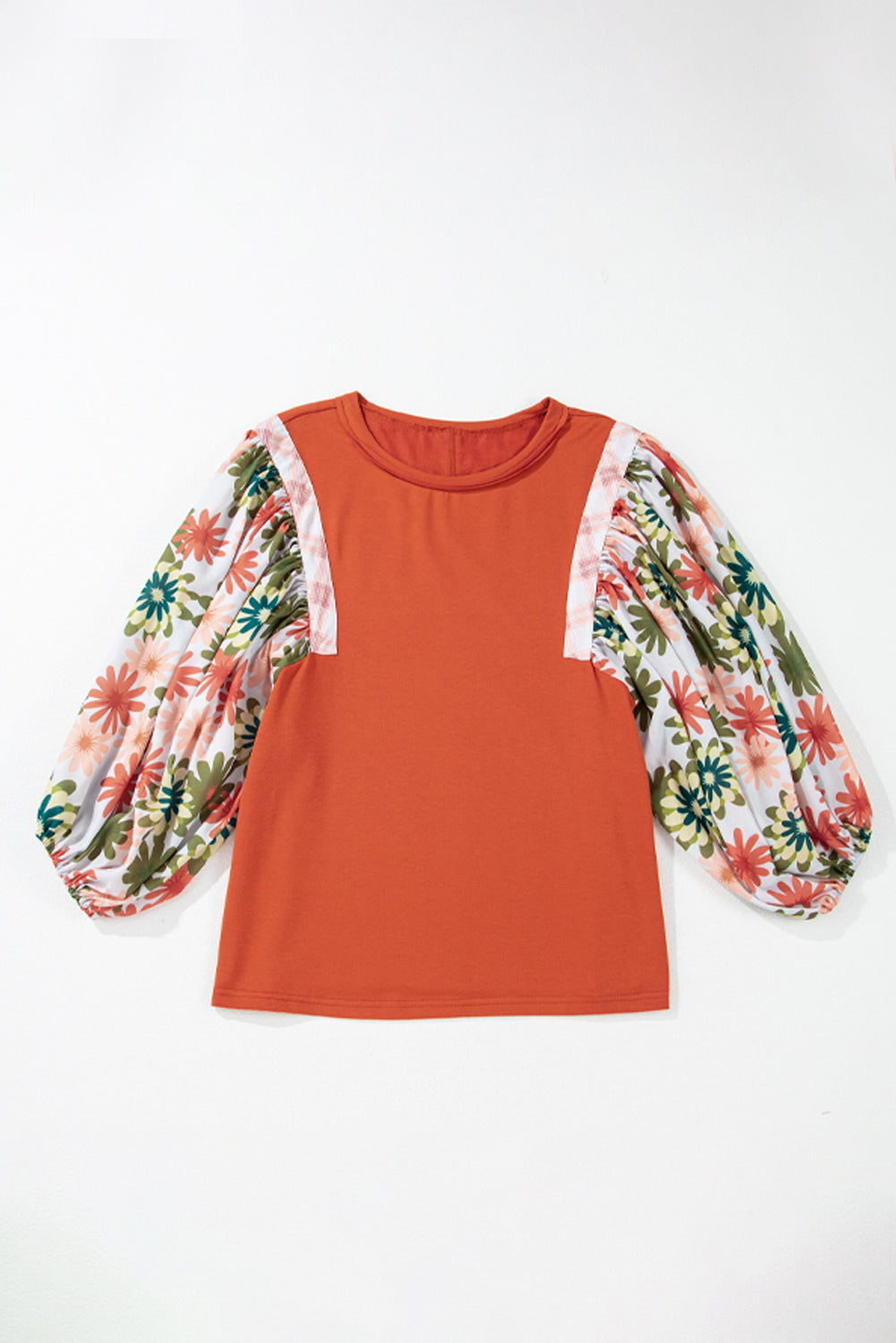 Orange top with floral sleeves on a white background