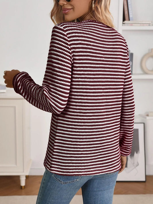 person wearing a long sleeve striped blouse