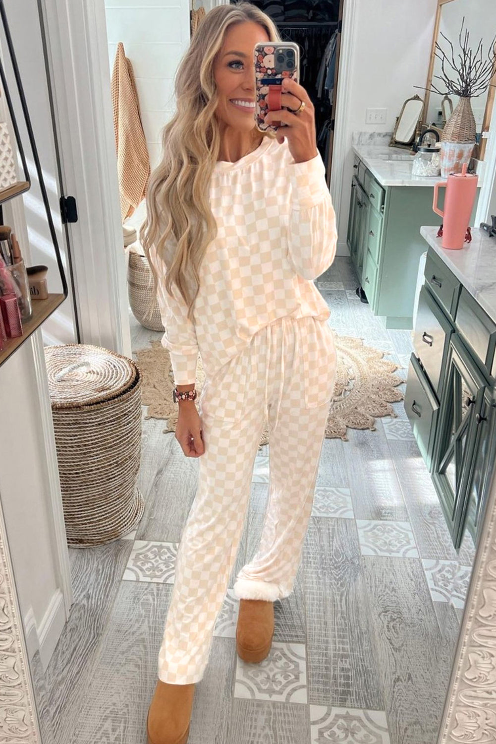 Woman taking a mirror selfie wearing a textured white outfit in a home setting.