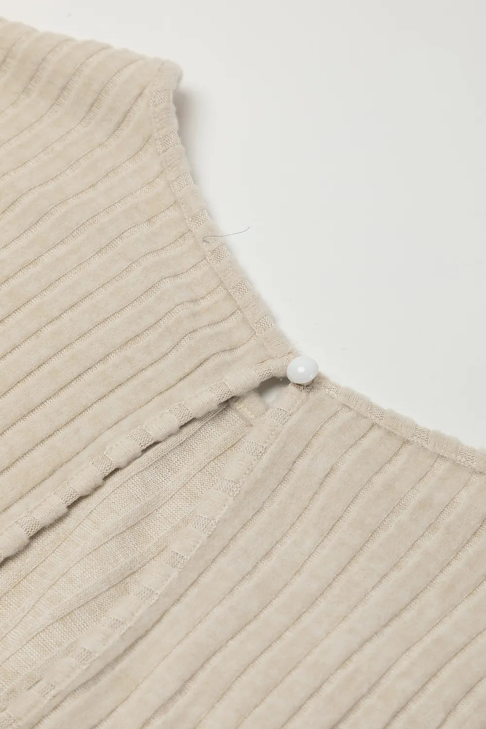 Close-up of a beige textured fabric with a white background