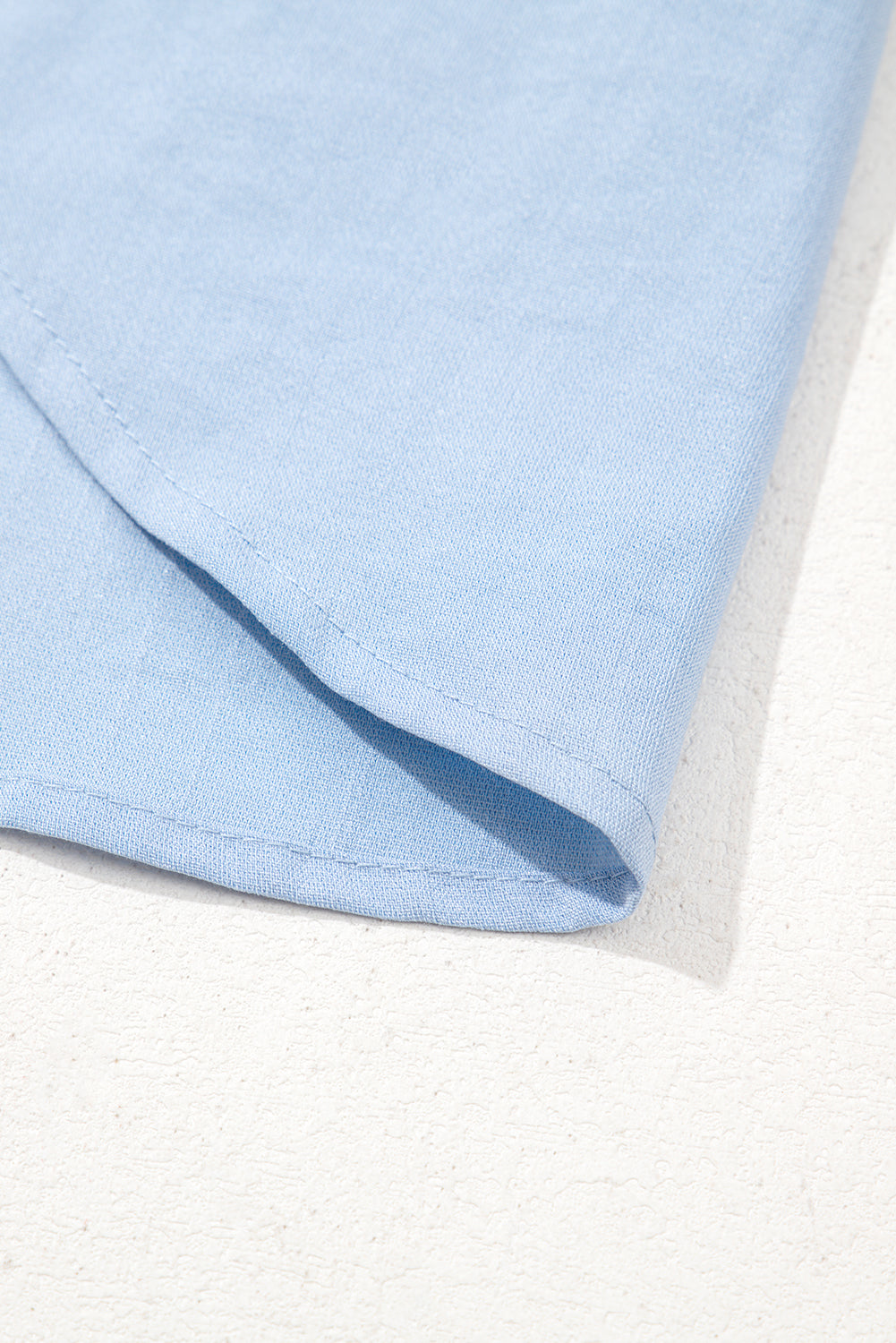 Close-up of light blue fabric on a white background