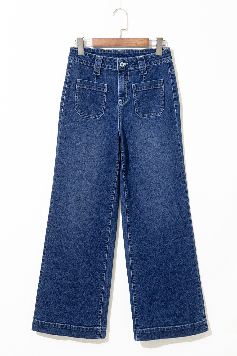 Blue jeans on a hanger against a white background
