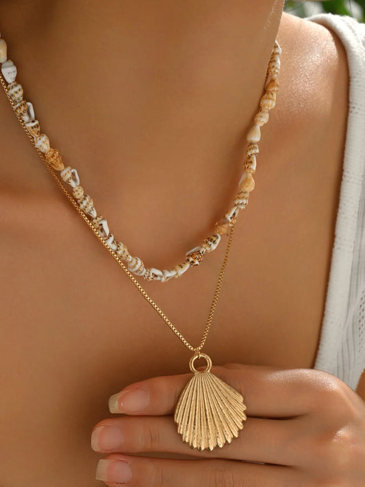 Necklace with shell pendant and seashell bead chain on a person's neck