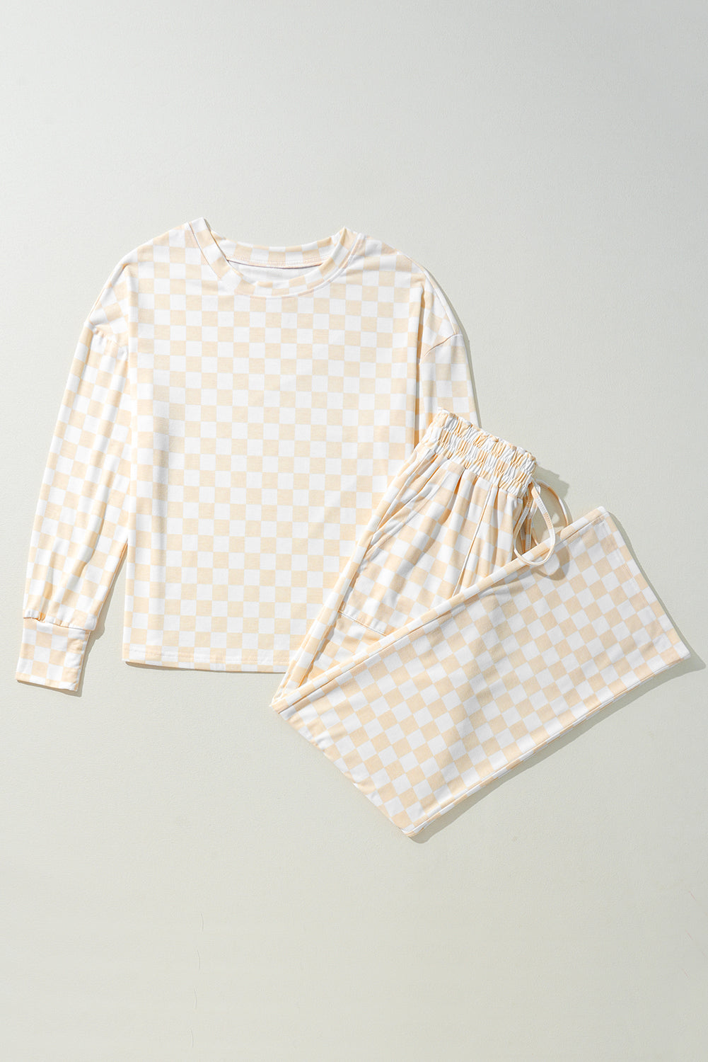 White pajama set with yellow pattern on a light gray background